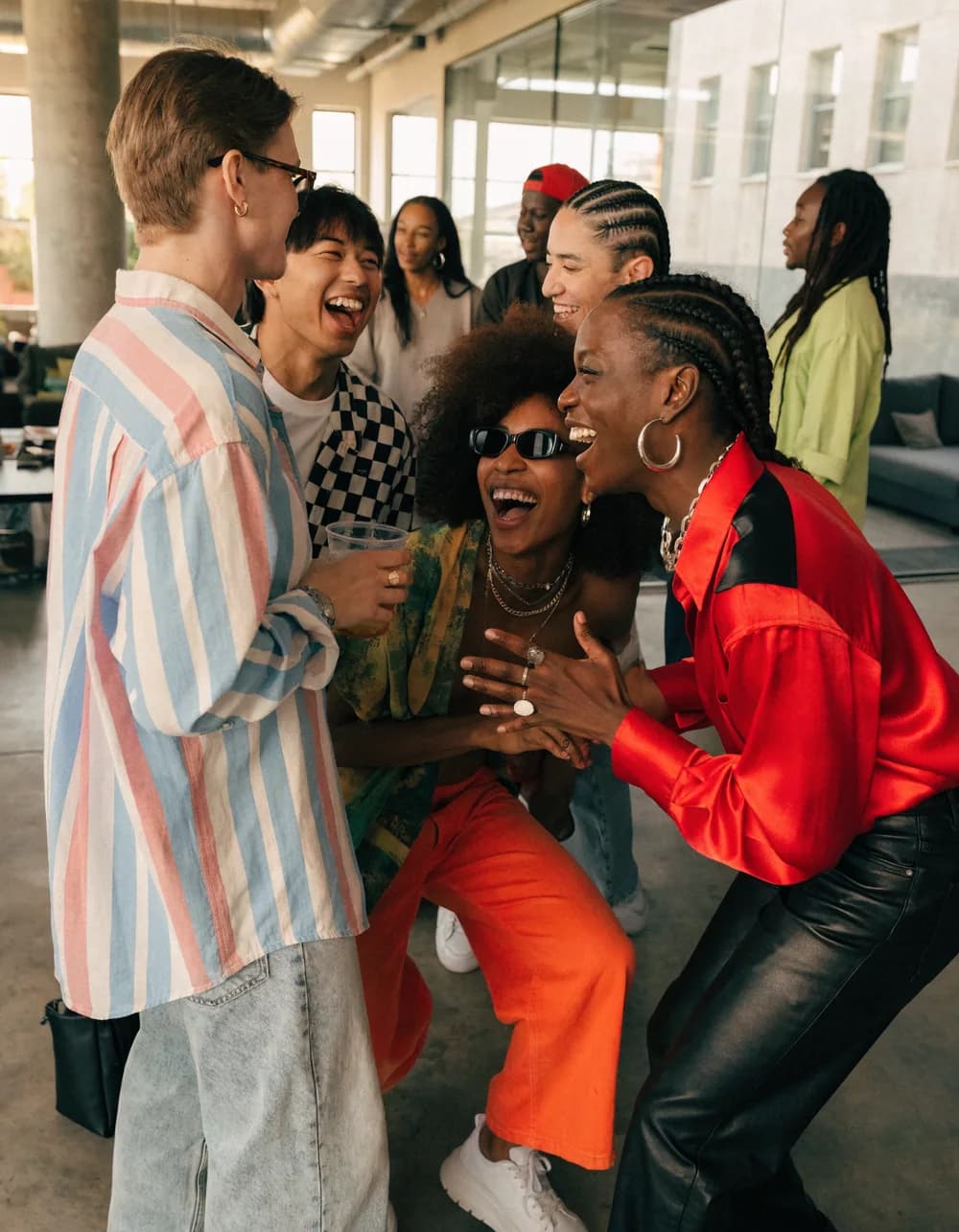 A group of friends laughing together at a gathering.